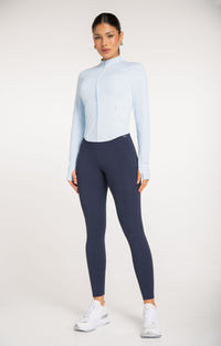 Motion Contour Jacket in Celeste Sky with navy leggings - women's activewear, front full length view